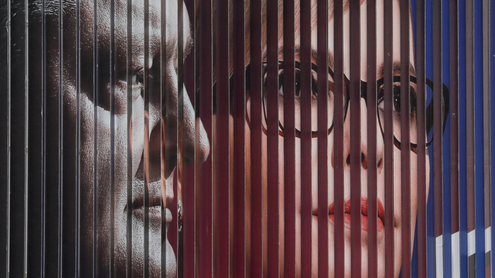 An election campaign poster with portraits of Ukrainian President Petro Poroshenko, left, and opposition politician Yulia Tymoshenko, right, is on display in Kiev, Ukraine March 4, 2019 [Valentyn Ogirenko/Reuters]