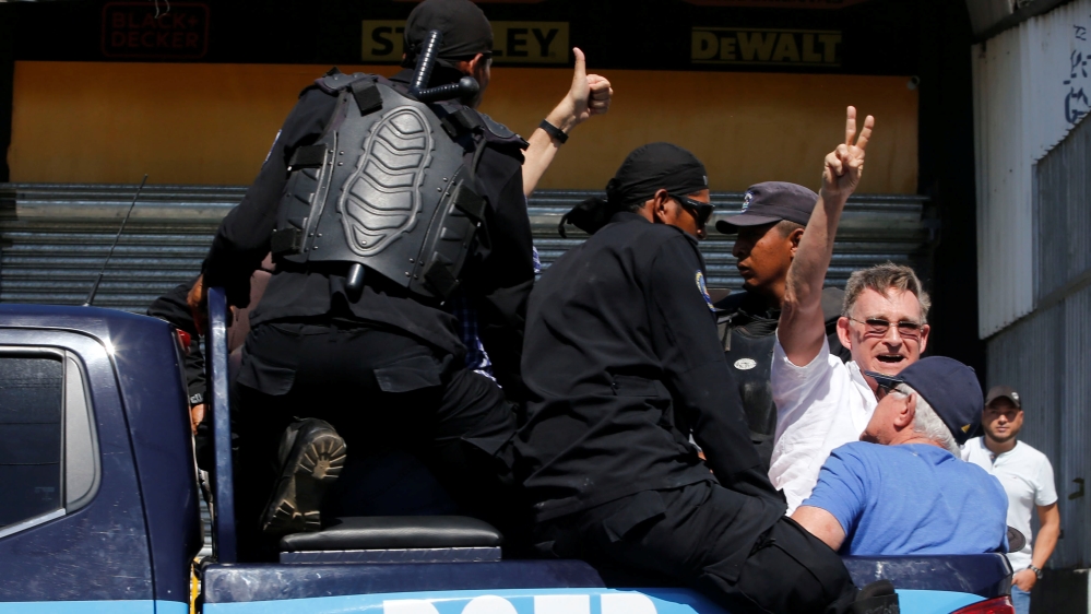 A demonstrator gestures as he is detained by riot police during a protest against the government of Nicaragua''s President Daniel Ortega in Managua