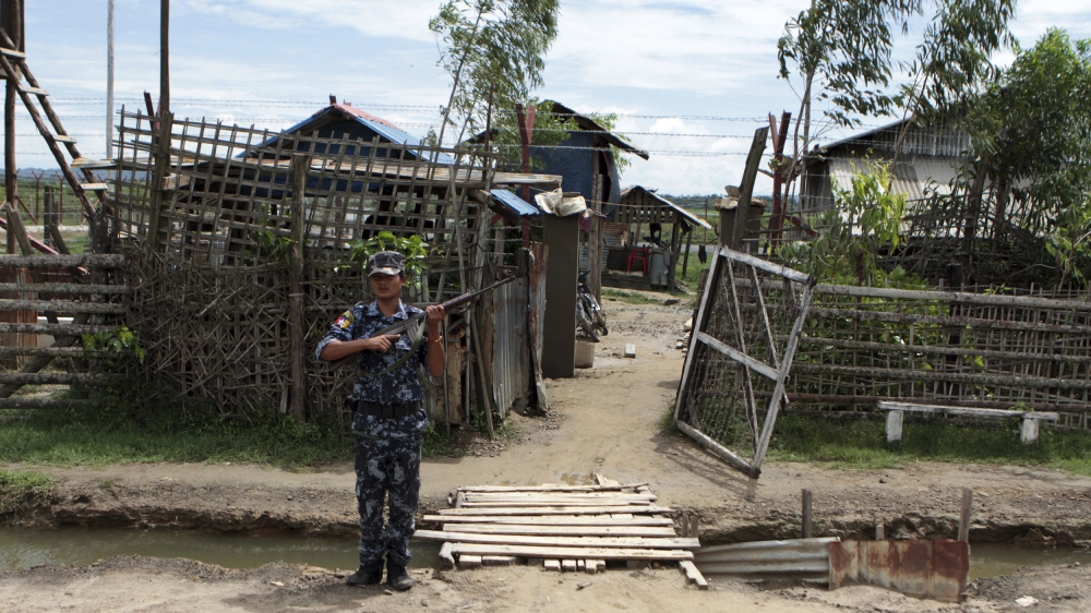 A police officer provides security on a road on the way to Ngakuya receiving camp, Maung Daw, the border town of northen Rakhine State, Myanmar, during a government organised media trip June. 28, 2018