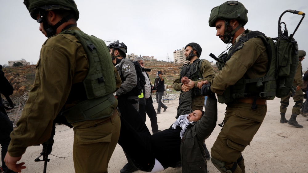 Israeli forces detain a Palestinian demonstrator during a protest demanding Israel to release Palestinian teenager Ahed Tamimi, near Israel''s Ofer Prison near the West Bank city of Ramallah