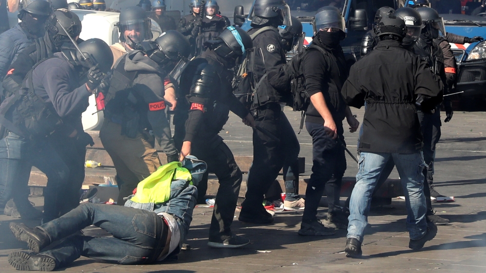 Riot police drag a protester during a demonstration of the yellow vests movement in Paris [Yves Herman/Reuters]