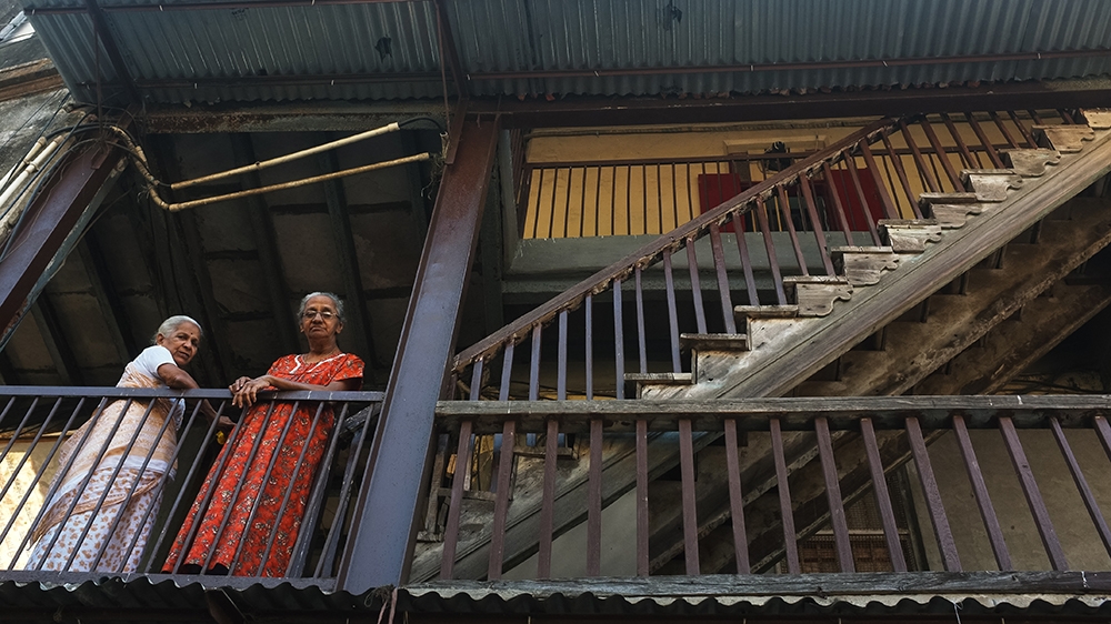 Two women, who spent their childhood in Kranti Nagar chawl, do what they enjoy best – watching passersby together