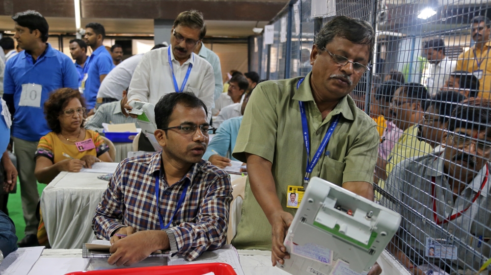 Election staff members count votes at a vote counting centre in Mumbai