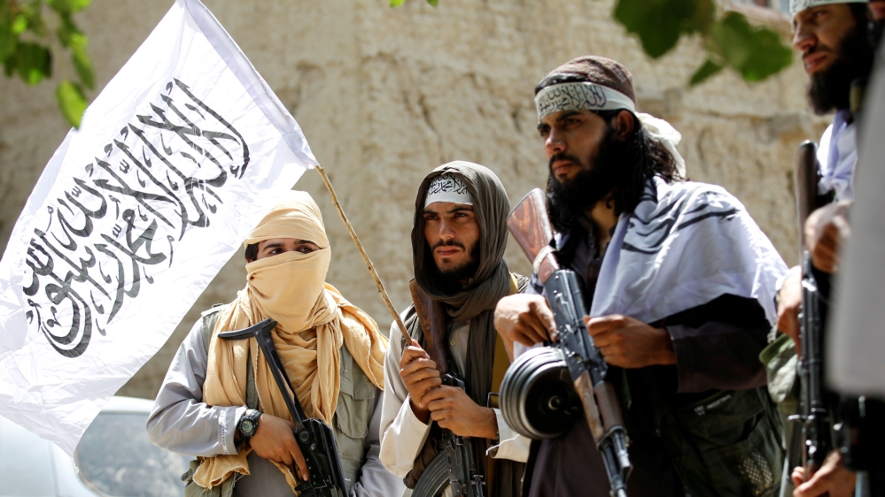 FILE PHOTO: Taliban walk as they celebrate ceasefire in Ghanikhel district of Nangarhar province, Afghanistan