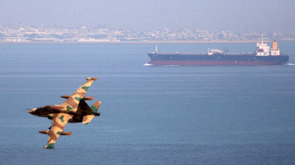 File photo of Iranian military fighter plane flying past an oil tanker during naval manoeuvres in the Gulf and Sea of Oman