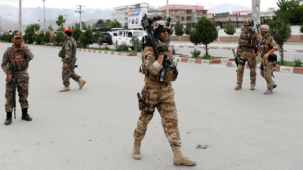Afghan security forces keep watch at the site of a blast in Kabul, Afghanistan