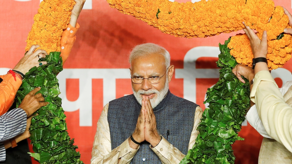 Indian Prime Minister Narendra Modi gestures as he is presented with a garland by Bharatiya Janata Party (BJP) leaders after the election results in New Delhi, India, May 23, 2019. REUTERS/Adnan Abidi