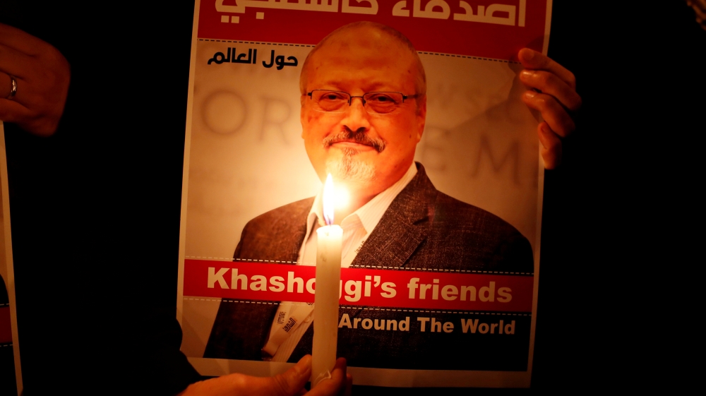 A demonstrator holds a poster with a picture of Saudi journalist Jamal Khashoggi outside the Saudi Arabia consulate in Istanbul