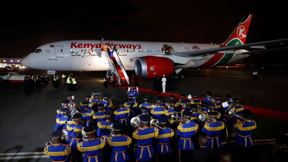 A police band plays as a Kenyan Airways Boeing 787 Dreamliner is seen during a ceremony marking the first non-stop flight, direct to New York City from Nairobi