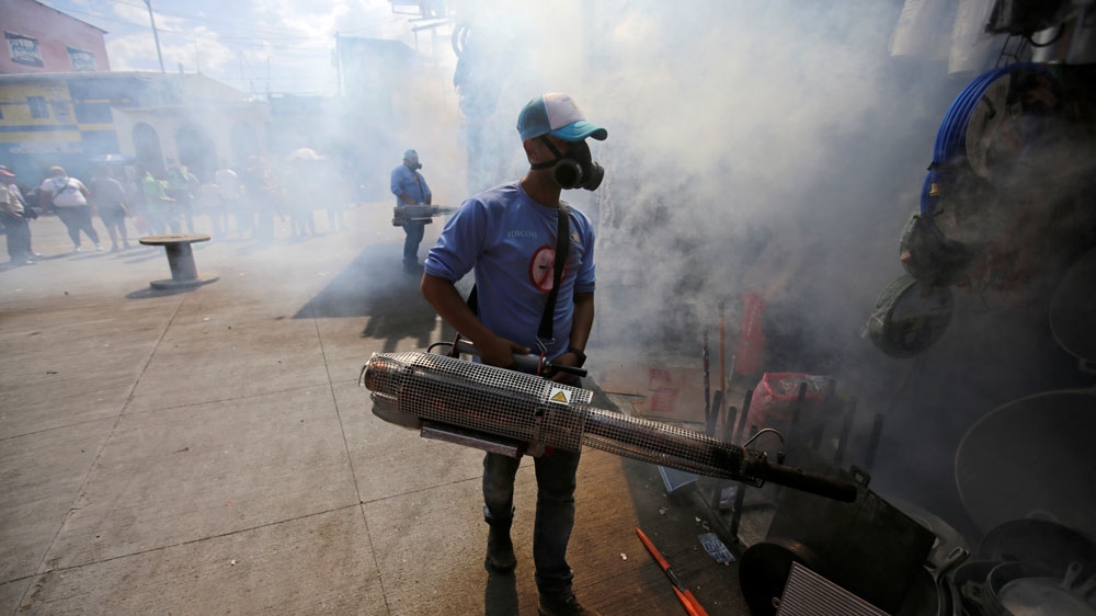A municipal worker fumigates a market to prevent the spread of dengue fever and other mosquito-borne diseases in Tegucigalpa