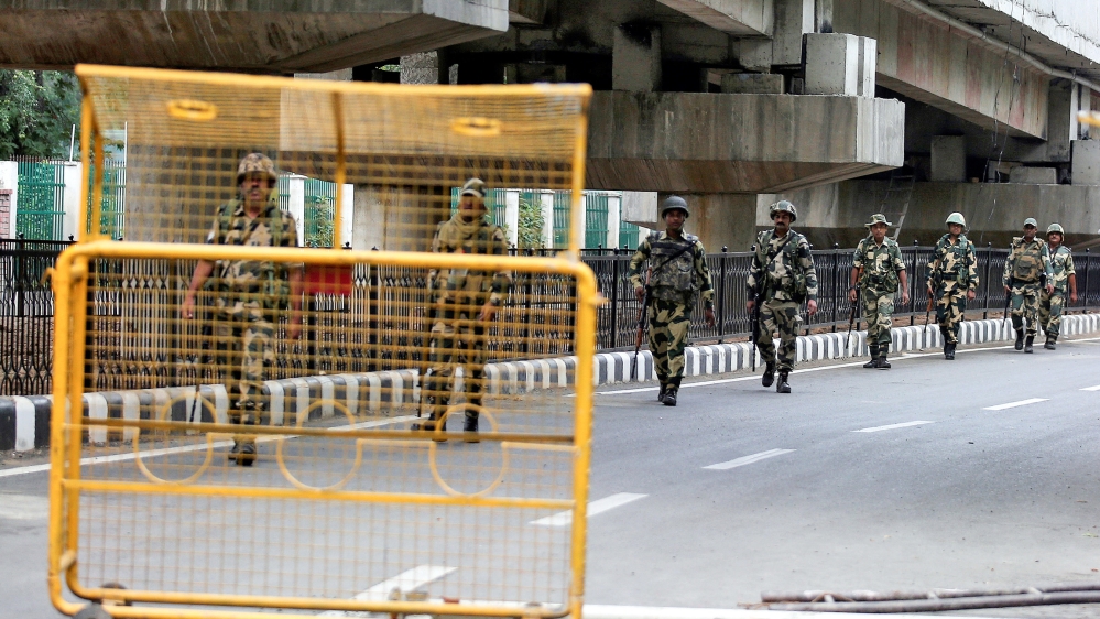 Indian security forces personnel patrol a deserted road during restrictions after the government scrapped special status for Kashmir, in Srinagar August 7, 2019. REUTERS/Danish Ismail