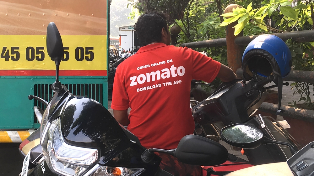 In this file photo taken on December 24, 2018 an Indian delivery man working with the food delivery app Zomato sits on his bike in Mumbai. An Indian food service has sparked a national debate and set