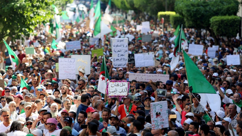 Demonstrators march as they shout slogans during an anti-government protest in Algiers
