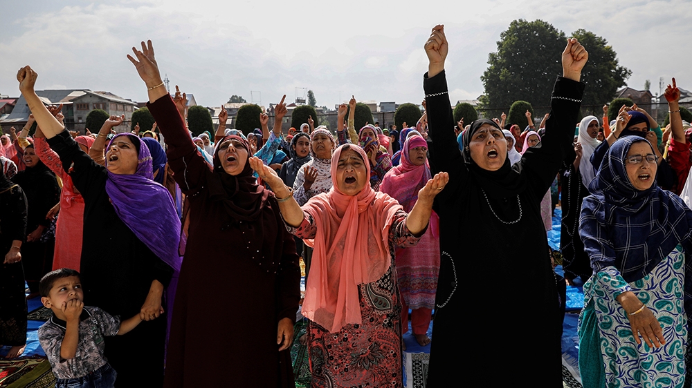 Kashmiri women shout pro-freedom slogans before offering the Eid-al-Adha prayers at a mosque during restrictions after the scrapping of the special constitutional status for Kashmir by the Indian gove