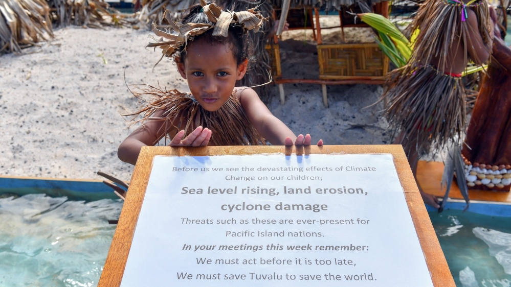 A child waits for New Zealand's Prime Minister Jacinda Ardern to arrive for the Pacific Islands Forum (PIF) in Funafuti, Tuvalu, 14 August 2019
