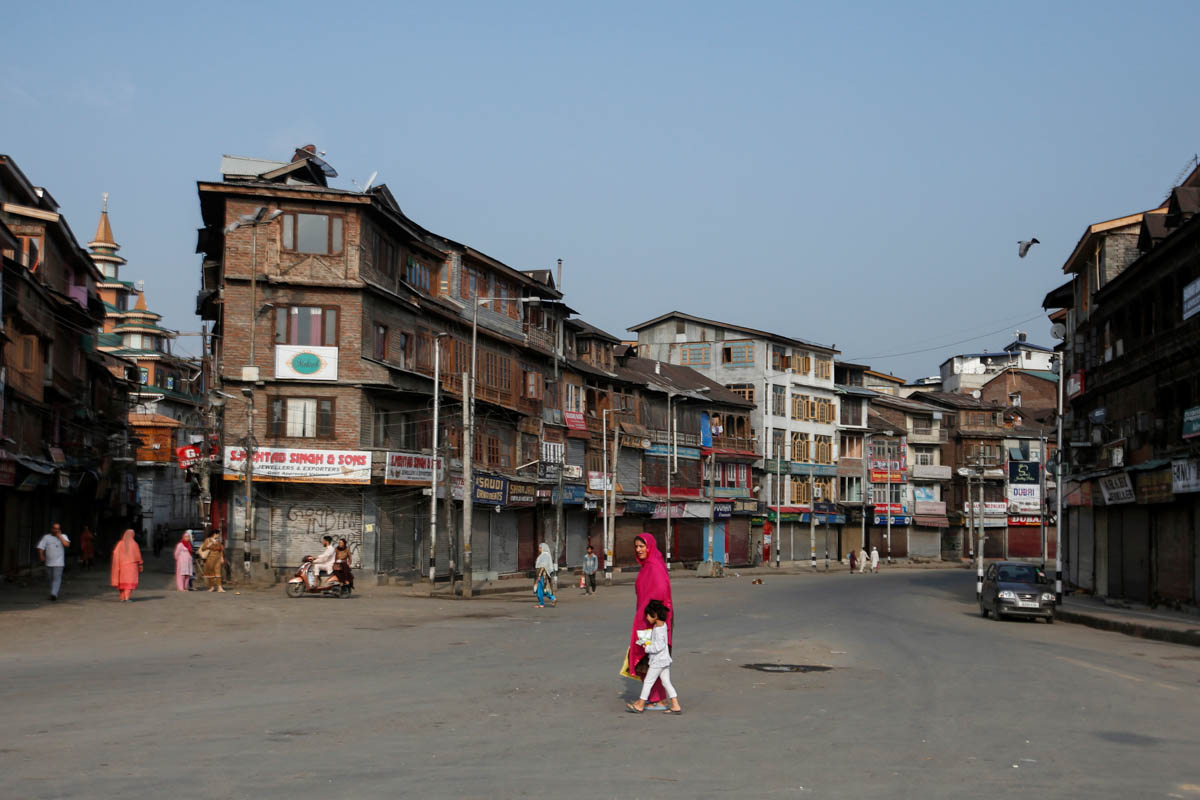 Residents cross a street during restrictions in Srinagar, August 5, 2019. REUTERS/Danish Ismail