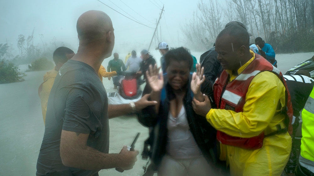 Volunteers rescue several families that arrived on small boats from the rising waters of Hurricane Dorian, near the Causarina bridge in Freeport, Grand Bahama