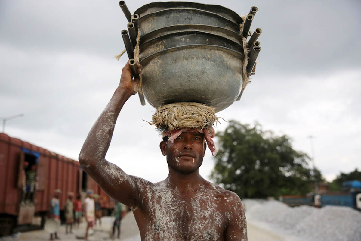 A worker at the stone loading site in Birpara area of Dooars. Big, heavy stones arrive from the hills of Bhutan, which is only 20kms from the region, and are broken down into smaller stones before loa