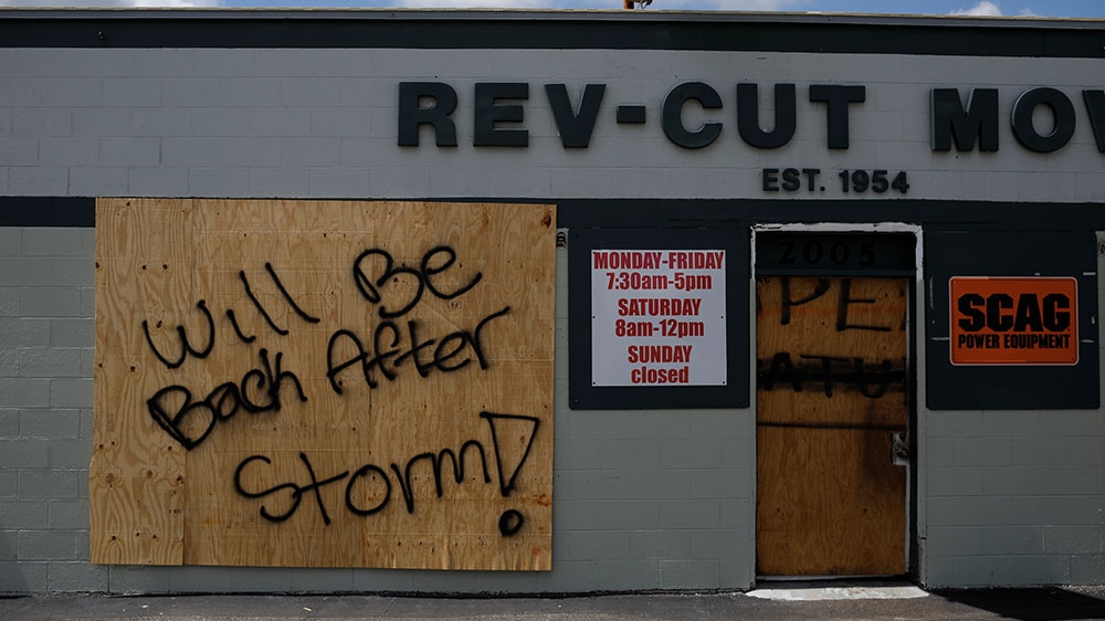 A boarded-up business with ‘Will be back after storm’ painted on it is seen before the arrival of Hurricane Dorian in Cocoa, Florida