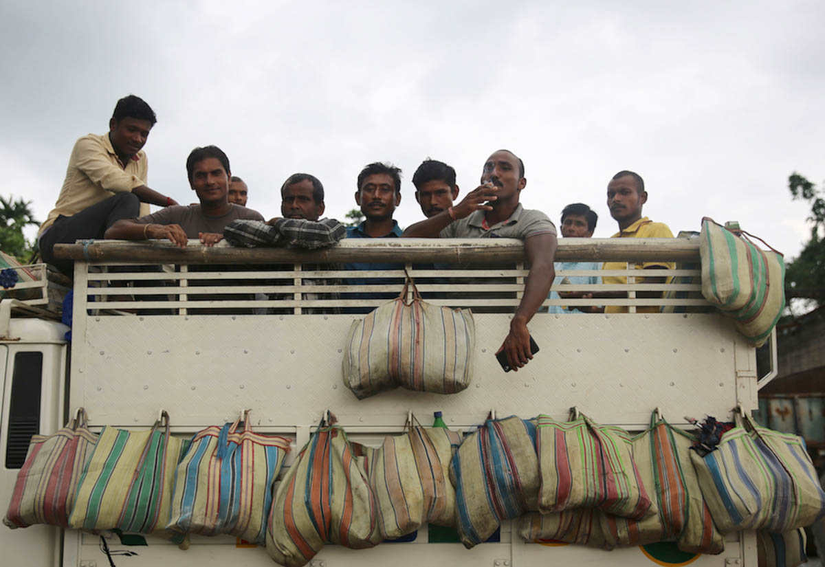 Stone workers load in lorry to return home after a day’s work.