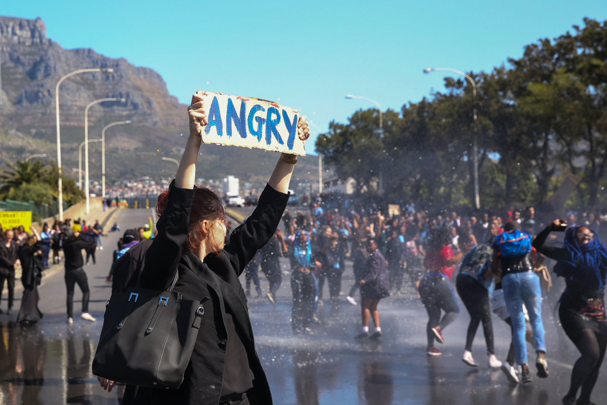 Not deterred, protesters continued to block streets inside the city center bringing traffic to a halt. After sitting on the streets singing the national anthem they were given a warning by police to l