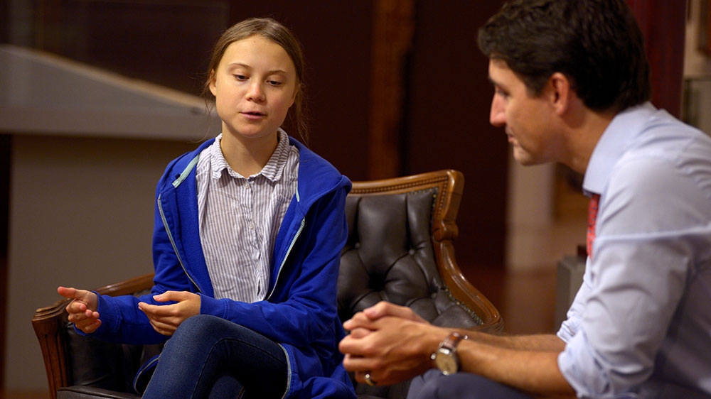 Canada’s Prime Minister Justin Trudeau greets Swedish climate change teen activist Greta Thunberg before a climate strike march in Montreal, Quebec