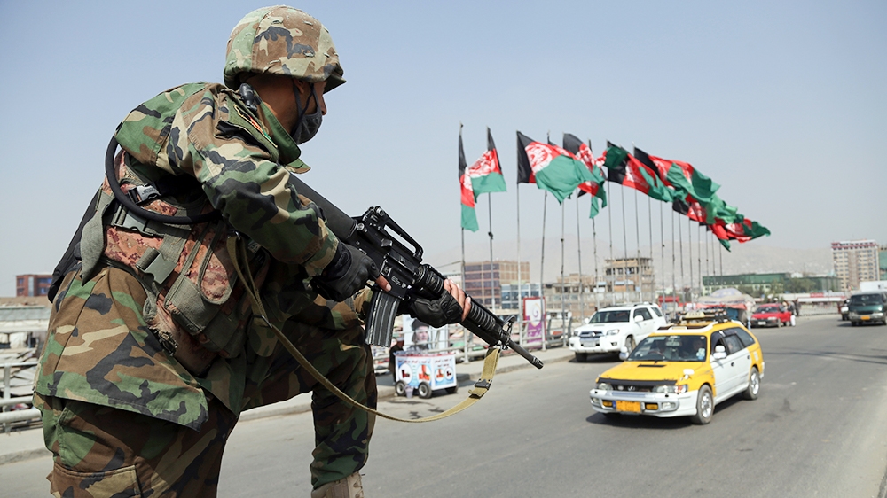 In this Tuesday, Sept. 24, 2019 photo, An Afghan National Army soldier stand guard at a checkpoint ahead of presidential elections scheduled for Sept. 28, in Kabul, Afghanistan. Millions of Afghans ar
