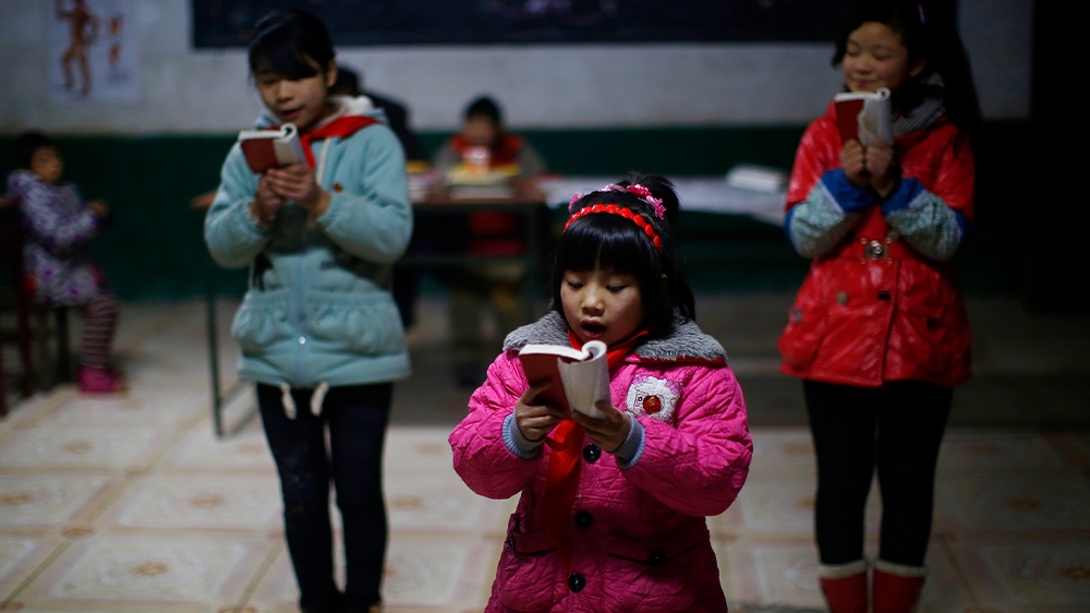 Students read a lecture from Mao Zedong’s ‘Little Red Book’ at the Democracy Elementary and Middle School in central Henan province in December 2013.