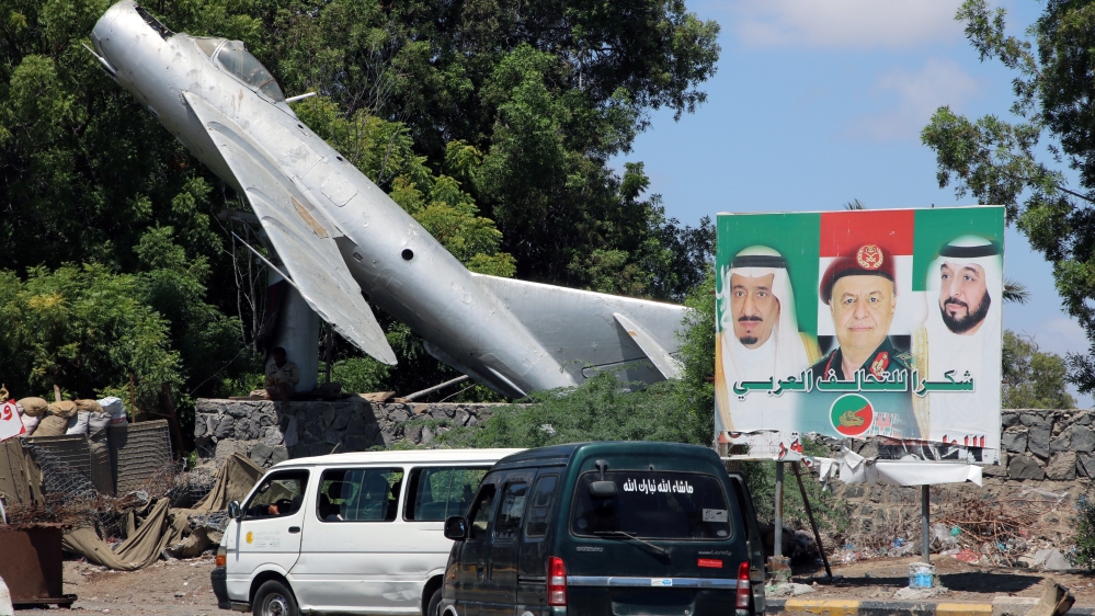 Vans drive past a billboard with posters of (L-R) Saudi King Salman bin Abdulaziz, Yemen''s President Abdu-Rabbu Mansour Hadi and President of the United Arab Emirates, Sheikh Khalifa bin Zaid, in Aden