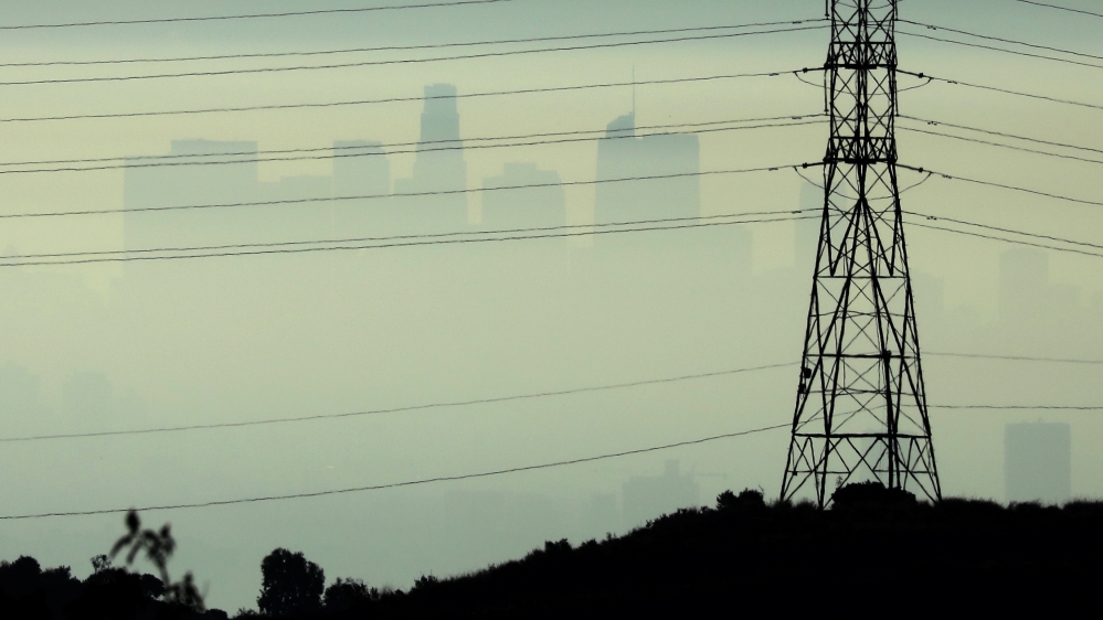 Downtown Los Angeles is seen behind an electricity pylon through the morning marine layer in Los Angeles
