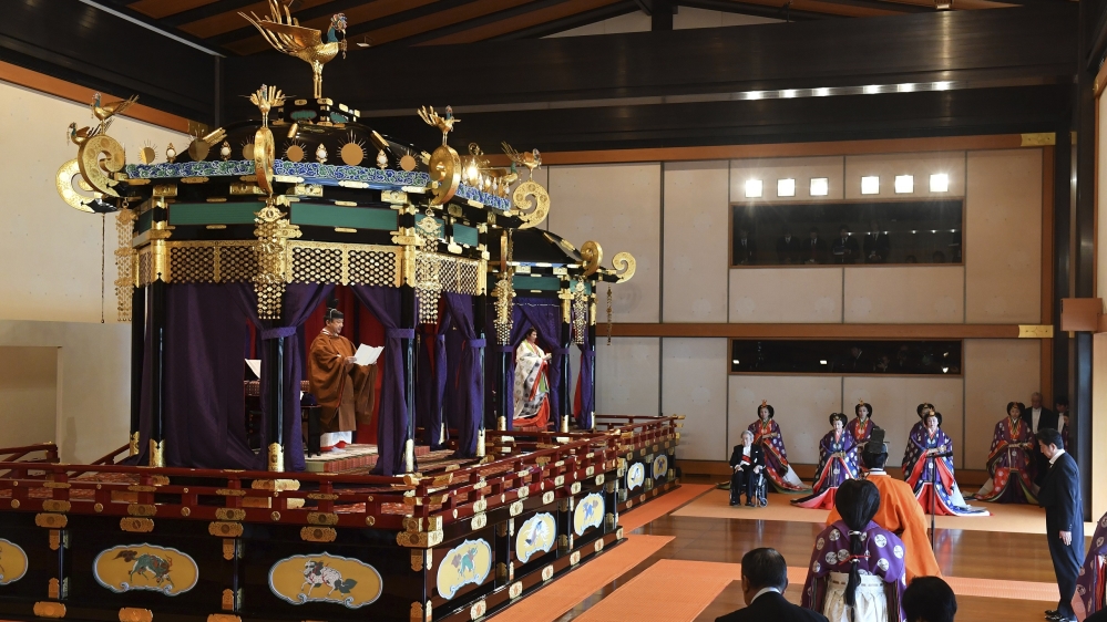 Japan’s Emperor Naruhito, left, delivers his speech as Empress Masako, second from left, and other Japanese officials attend the enthronement ceremony at the Imperial Palace in Tokyo on Tuesday
