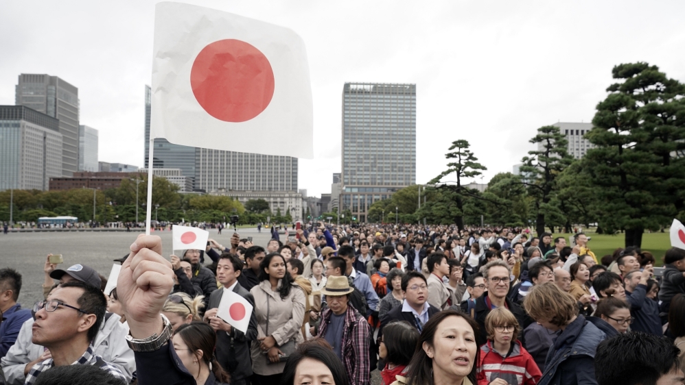 Well-wishers gather outside the Imperial Palace in Tokyo to greet the new emperor