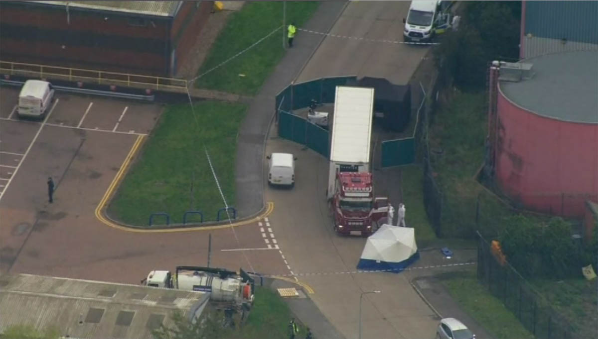 An aerial view as police forensic officers attend the scene after a truck was found to contain a large number of dead bodies, in Thurock, South England, early Wednesday Oct. 23, 2019. Police in southe