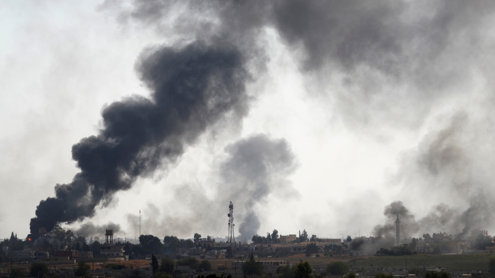 Smoke rises over the Syrian town of Tel Abyad, as seen from the Turkish border town of Akcakale