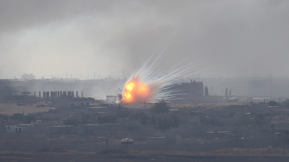 An explosion is seen over the Syrian town of Ras al-Ain as seen from the Turkish border town of Ceylanpinar, Sanliurfa province, Turkey, October 12, 2019