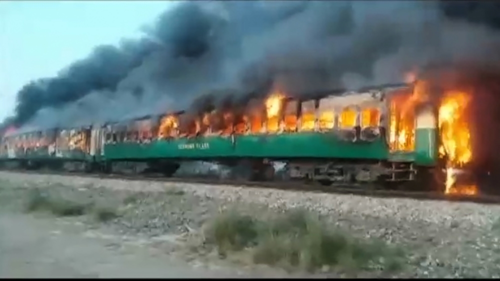 A fire burns a train carriage after a gas canister passengers were using to cook breakfast exploded, near the town of Rahim Yar Khan in the south of Punjab province, Pakistan October 31, 2019, in this