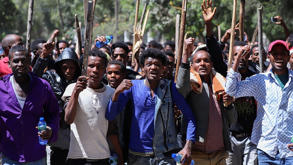 Oromo youth chant slogans during a protest in-front of Jawar MohammedO~s house, an Oromo activist and leader of the Oromo protest in Addis Ababa, Ethiopia, October 24, 2019. REUTERS/Tiksa Negeri