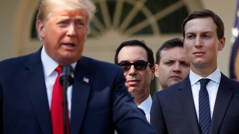 White House senior adviser Jarod Kushner (R) listens as U.S. President Donald Trump