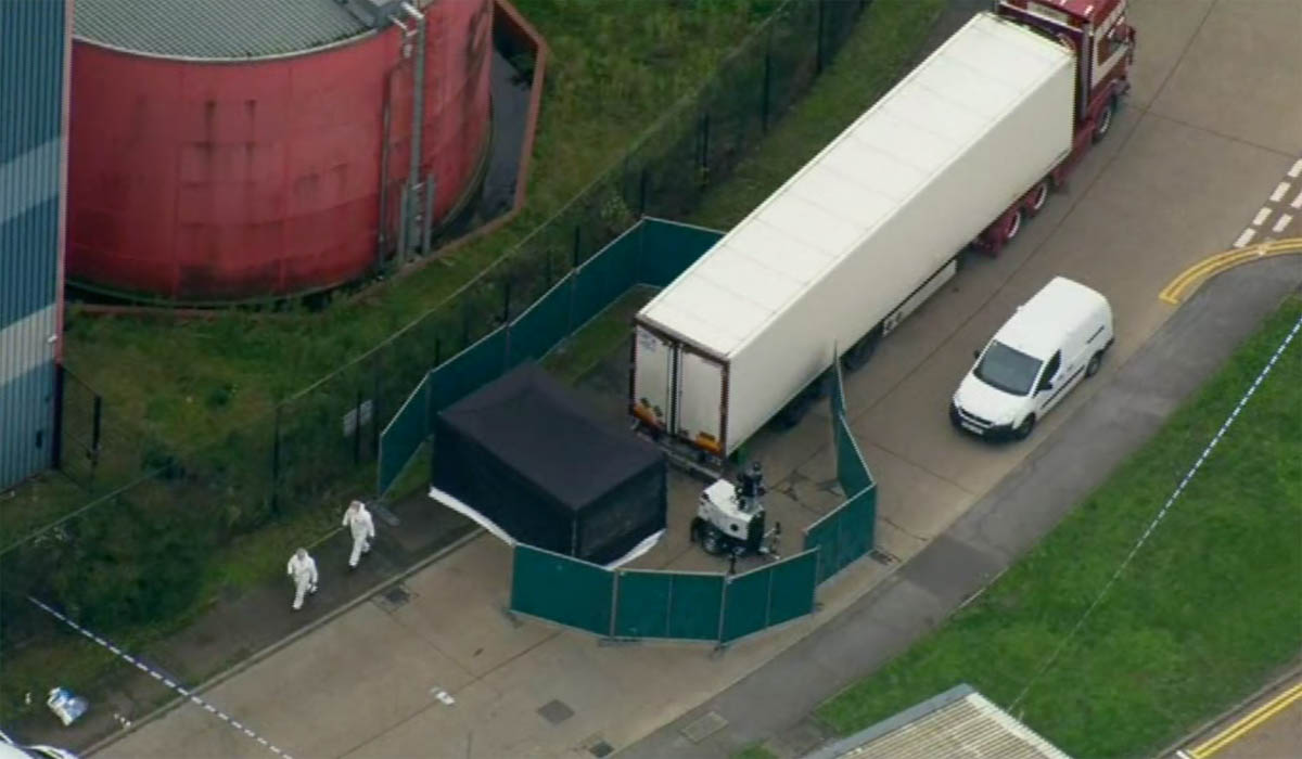 An aerial view as police forensic officers attend the scene after a truck was found to contain a large number of dead bodies, in Thurock, South England, Wednesday Oct. 23, 2019. Police in southeastern