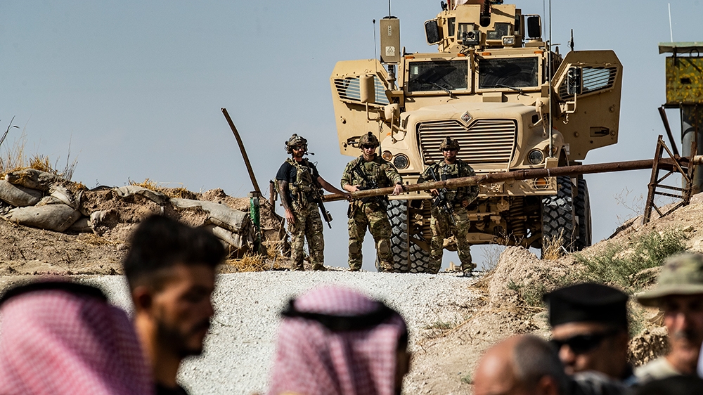 Syrian Kurds take part in a demonstration against Turkish threats at a US-led international coalition base on the outskirts of Ras al-Ain town in Syria's Hasakeh province near the Turkish border on Oc
