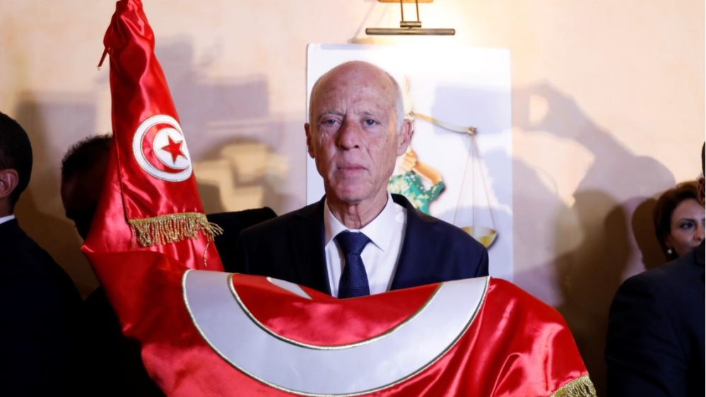 Tunisian presidential candidate Kais Saied reacts after exit poll results were announced in a second round runoff of the presidential election in Tunis