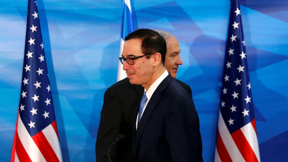 Israeli Prime Minister Benjamin Netanyahu walks behind U.S. Treasury Secretary Steven Mnuchin as they prepare to deliver joint statements during their meeting in Jerusalem