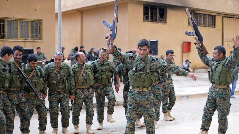 Fighters from a new border security force under the command of Syrian Democratic Forces (SDF) dance during a graduation ceremony in Hasaka, northeastern Syria, January 20, 2018