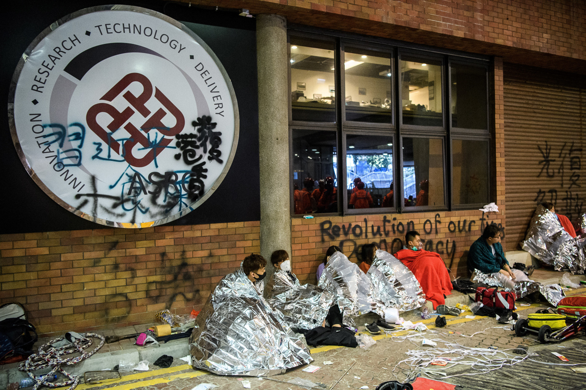 Unwell and injured protesters wait to take ambulances to leave the campus of the Hong Kong Polytechnic University in the Hung Hom district of Hong Kong on November 19, 2019. - A dwindling number of ex