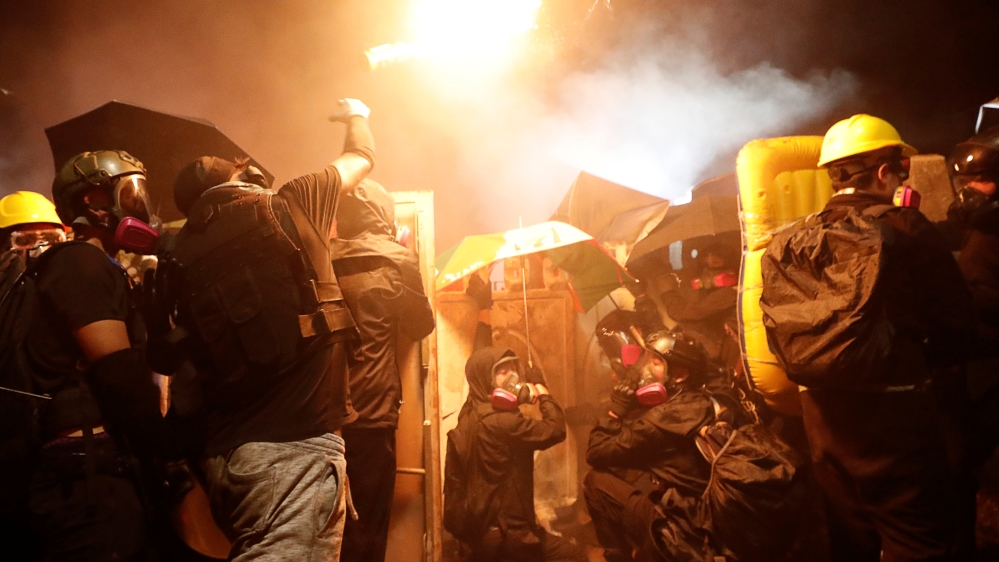 A protesters throws a molotov cocktail during a standoff with riot police at the Chinese University of Hong Kong
