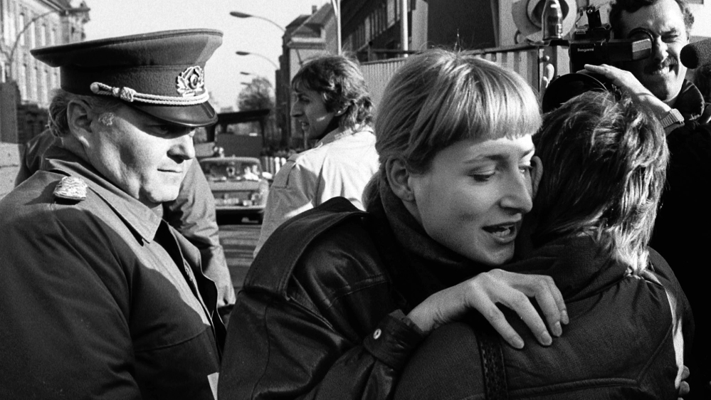 East and West Berlin women embracing, 1999