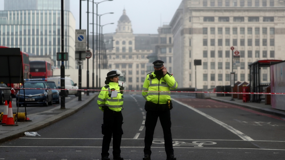 Police officers stand behind cordon at the scene of a stabbing on London Bridge, in which two people were killed, in London, Britain, November 30, 2019