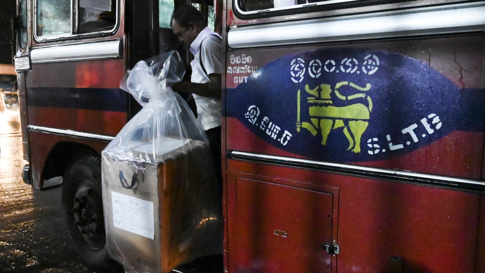 A Sri Lankan election official carries a ballot box to be transferred to a main counting centre after the presidential election voting centres closed, in Colombo on November 16, 2019