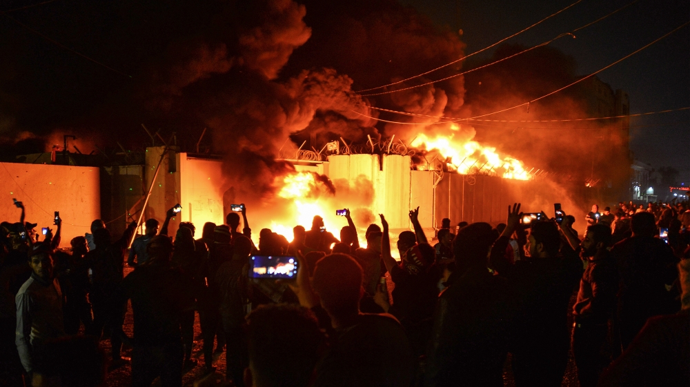 Iraqi demonstrators gather as flames start consuming Iran''s consulate in the southern Iraqi Shiite holy city of Najaf on November 27, 2019, two months into the country''s most serious social crisis in