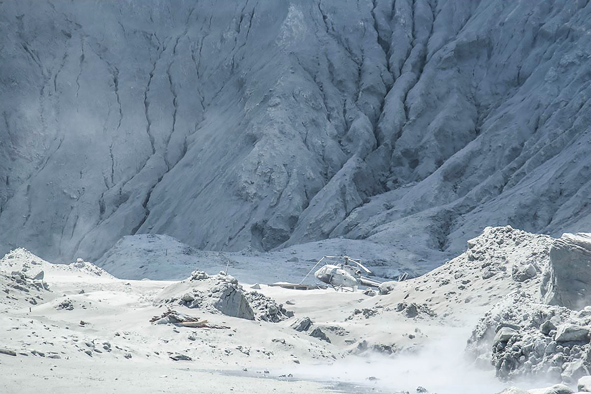 This handout photograph courtesy of Michael Schade shows wreckage of a helicopter amid ash minutes after the volcano on New Zealand''s White Island erupted on December 9, 2019. New Zealand police said